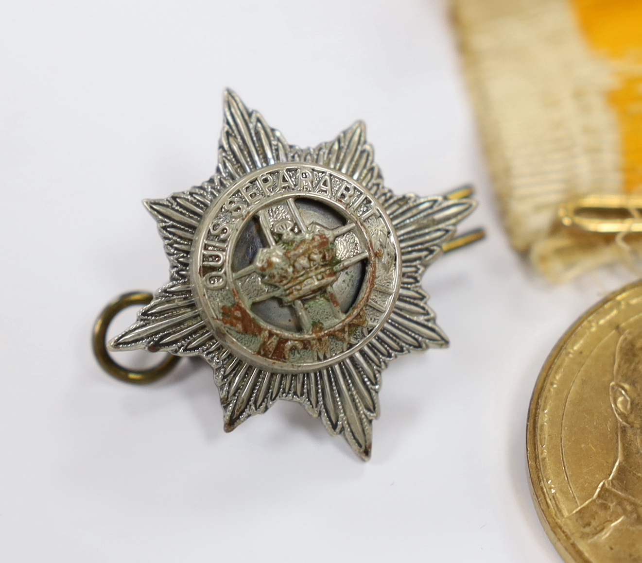 A Russian commemorative House of Romanov medal and a regimental clasp, 1922